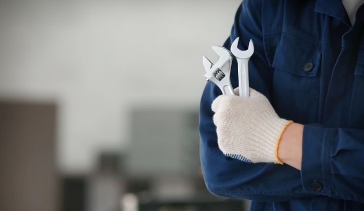 Maintenance worker holding tools for property repair and upkeep